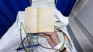 My POV looking down at a novel and EKG wires in my lap